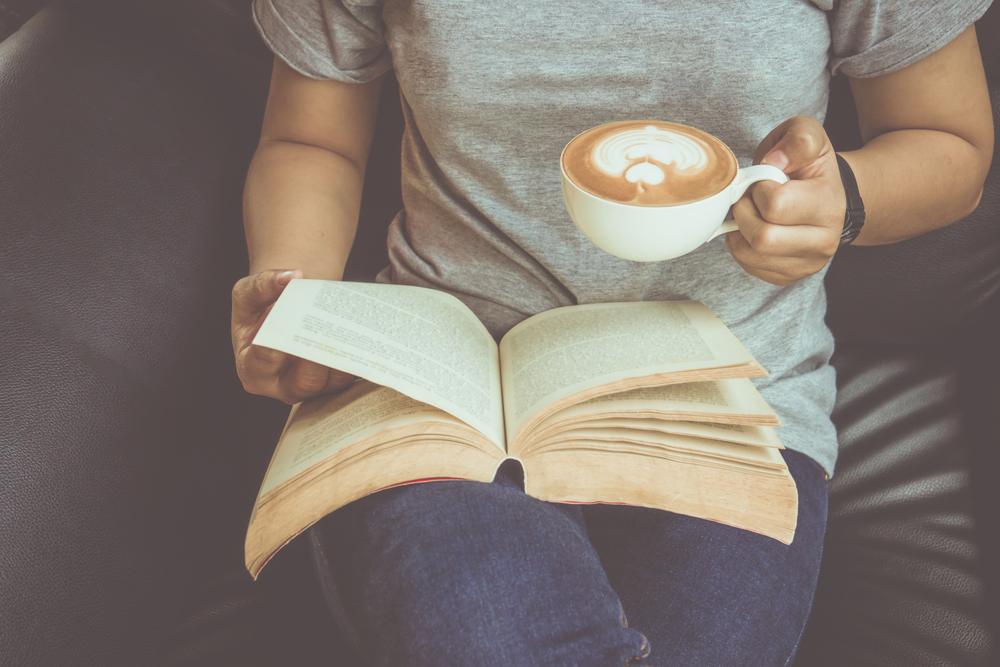 Reading a book with a cup of coffee.